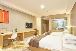 A hotel room with a bed, a desk, a chair, a TV, and a mirror. - Shanghai Xing Urban Garden Hotel (Shanghai)
