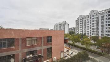 A multi-story building with a brick facade and large windows.