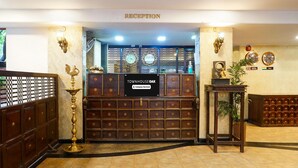 A reception area with a sign reading "TOWNHOUSE OAK" and a "RECEPTION" sign above. - Deluxe Shivajii Nagar (Pune)