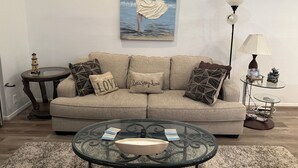 Living area - Cozy 2-bedroom condo on the water, with community pool and fitness center. (Montgomery)