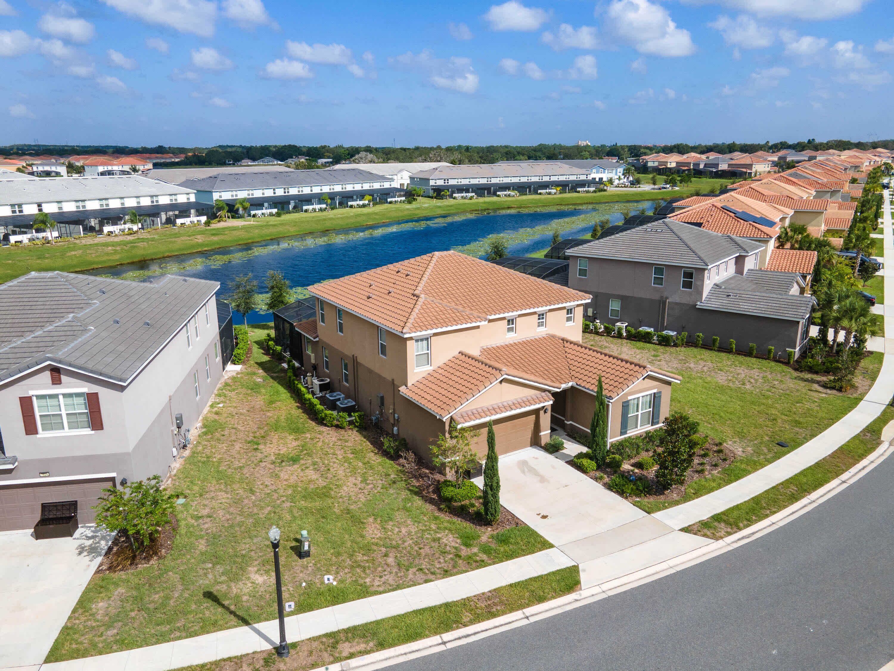 A residential area with houses, a canal, and a road.