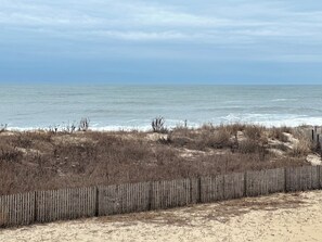 A beach with a wooden fence, sandy dunes, and the ocean. - Charming 2-bedroom condo with WiFi, AC in amazing Ocean City (Ocean City)