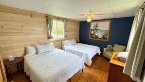 A room with two beds, a wooden ceiling, a painting of a landscape, and a window with curtains. - Bar Harbor Cottage Close to Acadia & Downtown Bar Harbor - Kitchen, AC, Wi-Fi, Fireplace (Sleeps 6). (Bar Harbor)