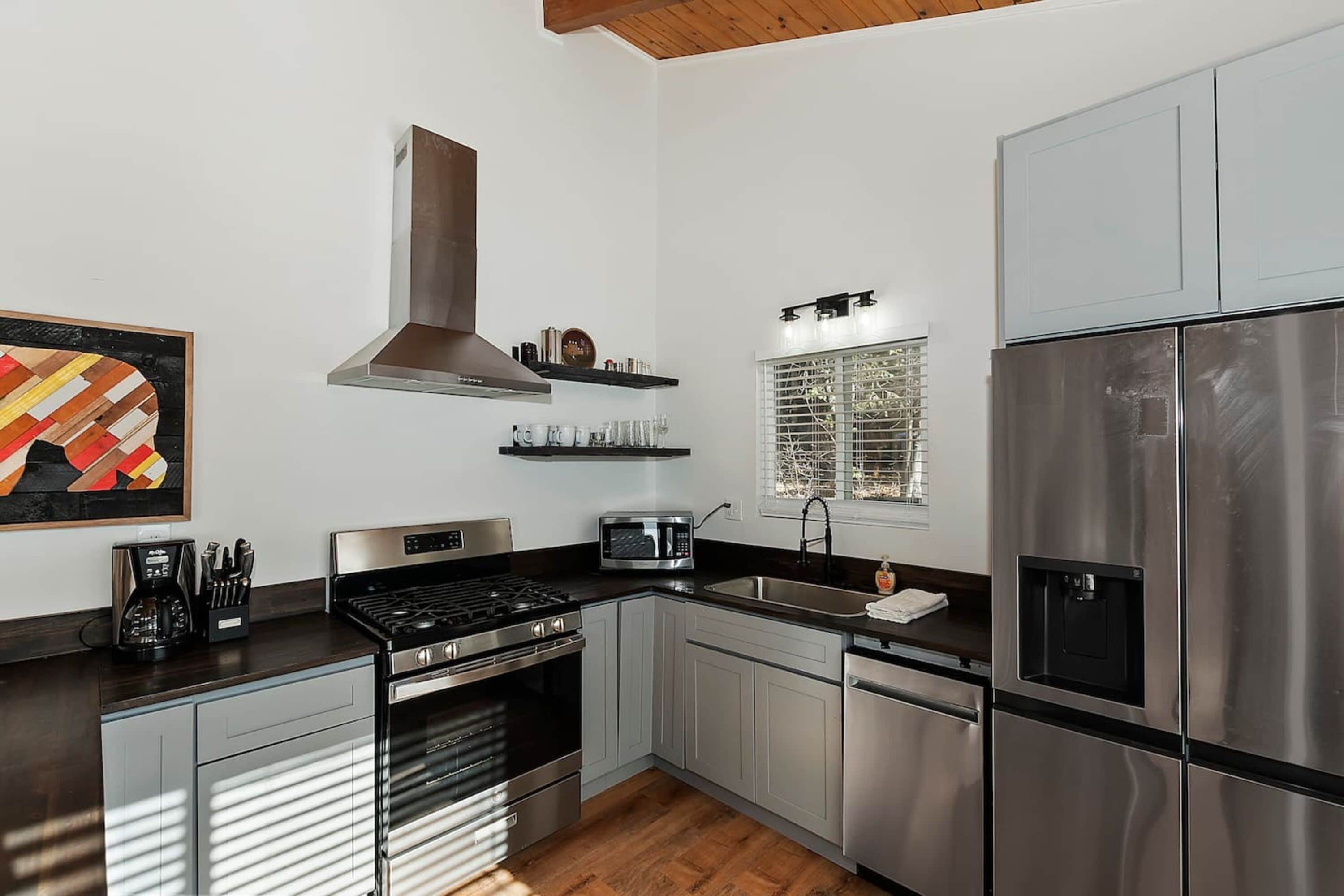 A modern kitchen with stainless steel appliances, a built-in oven, and a microwave.