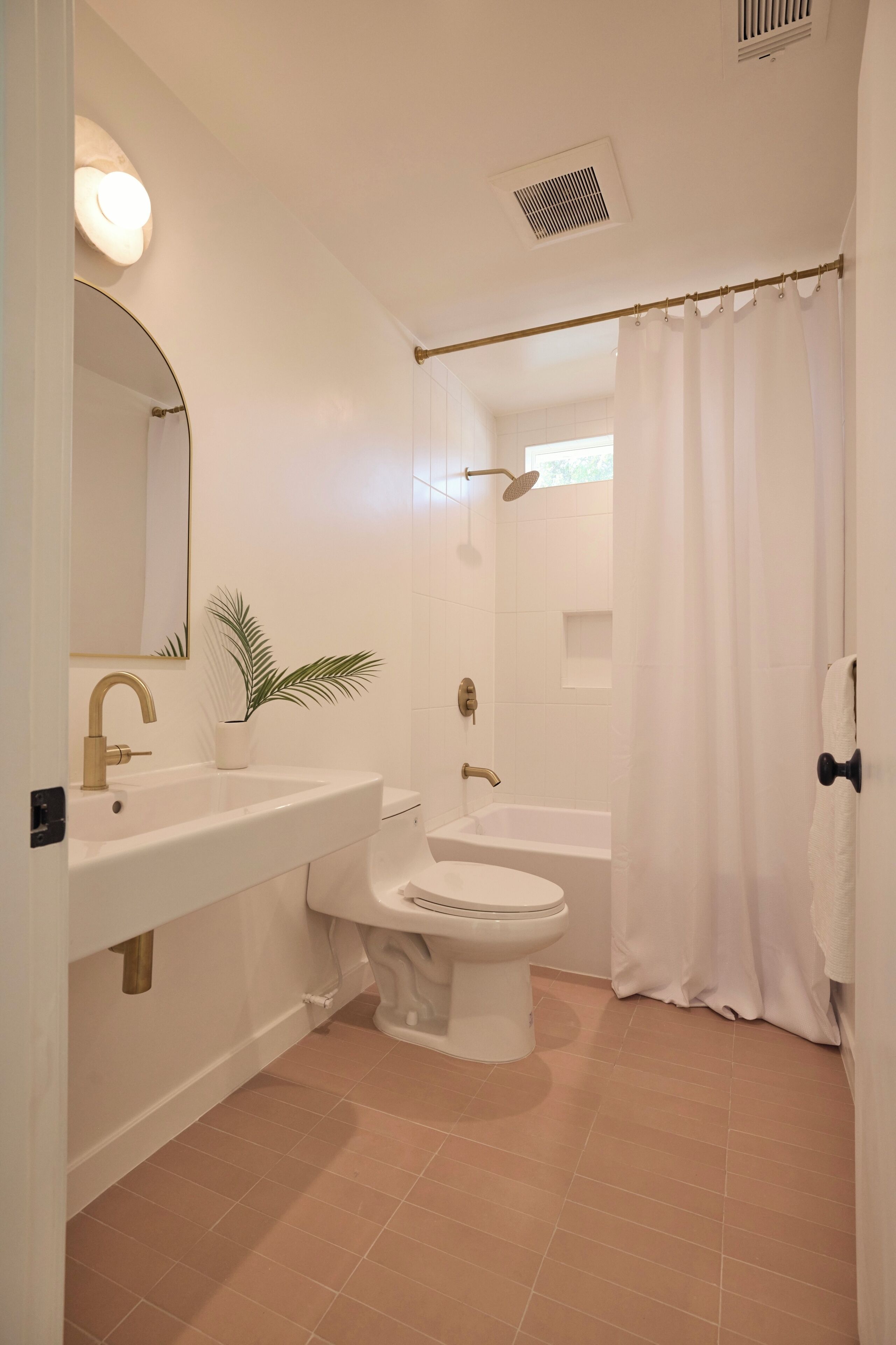 A bathroom with a sink, toilet, and bathtub.