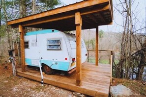 A mobile home with a wooden deck and a covered area. - The Cupola (Roscoe)