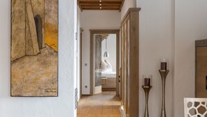A hallway with wooden flooring, a dining table, and a painting on the wall. - Penthouse Near Mittersill (Mittersill)