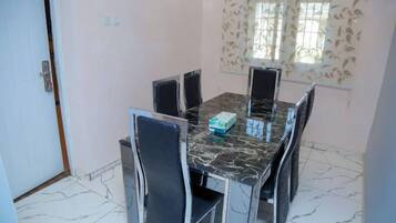 Deluxe Apartment, Balcony, City View | Dining room