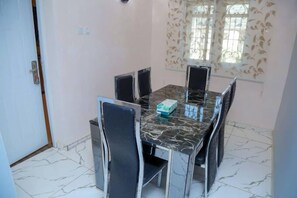 Deluxe Apartment, Balcony, City View | Dining room