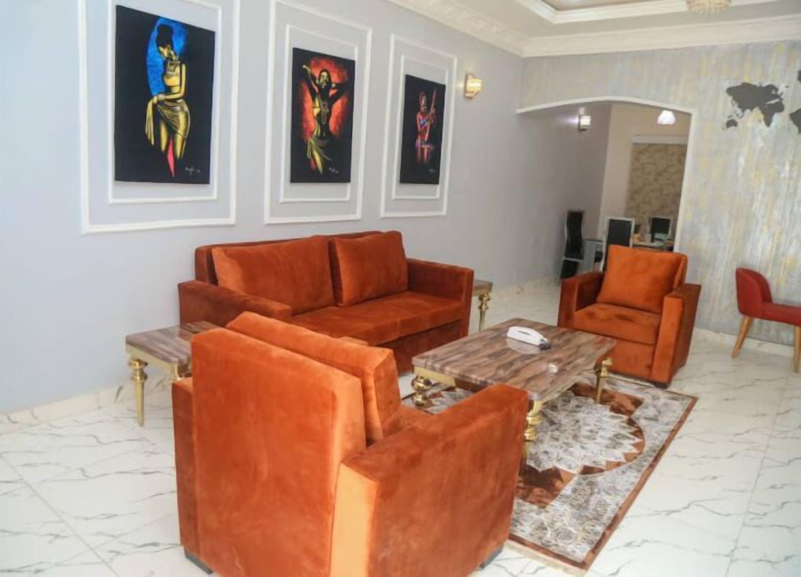A living room with a sofa set, a coffee table, and artwork on the wall.