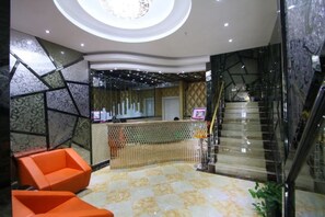 A hotel lobby with a reception desk, seating area, and a staircase. - Fujimengge Hotel Shanghai (Shanghai)