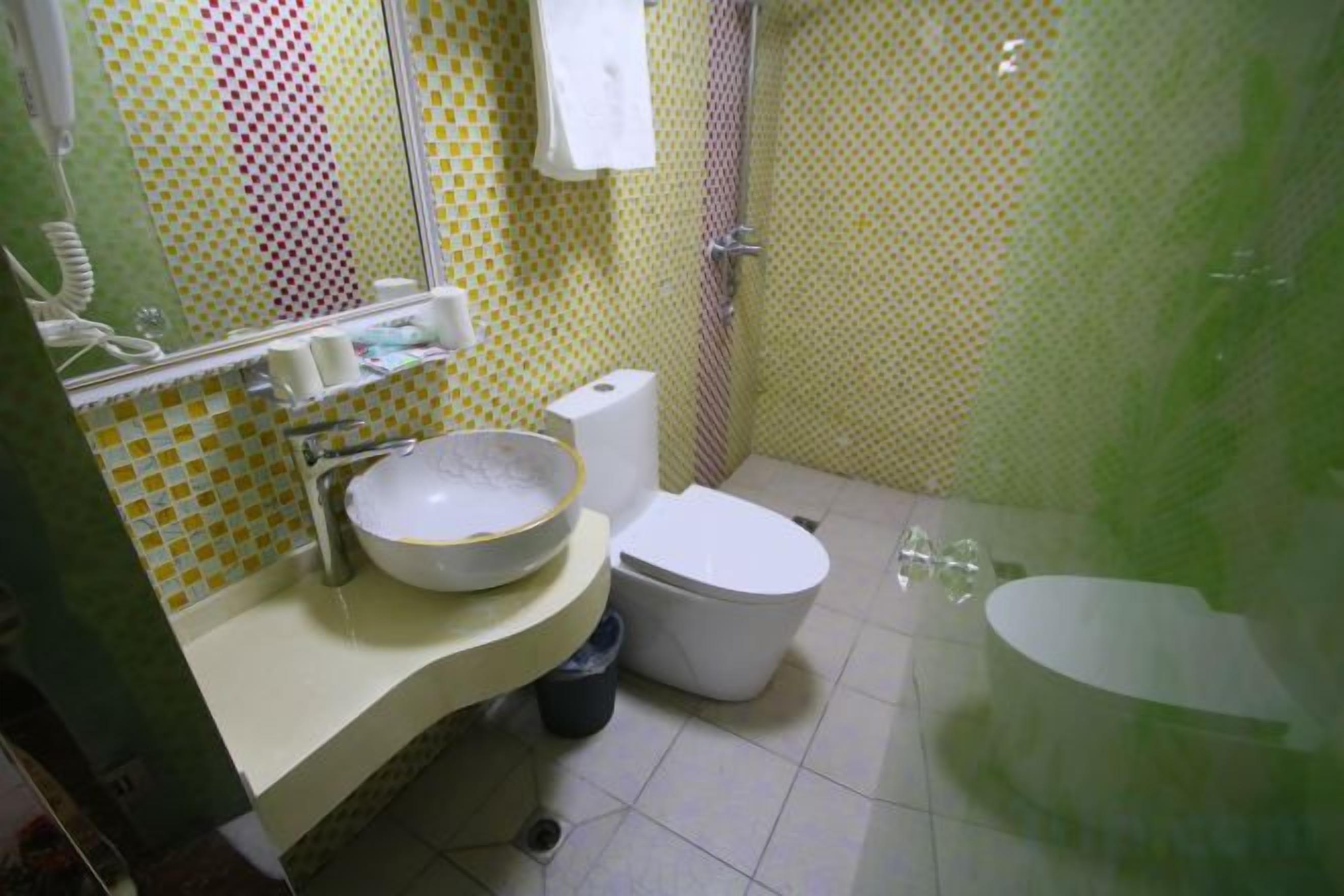 A bathroom with a sink, toilet, and shower.