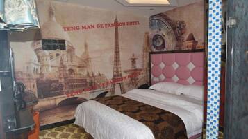 A hotel room with a bed, a poster of a cityscape, and a patterned carpet.
