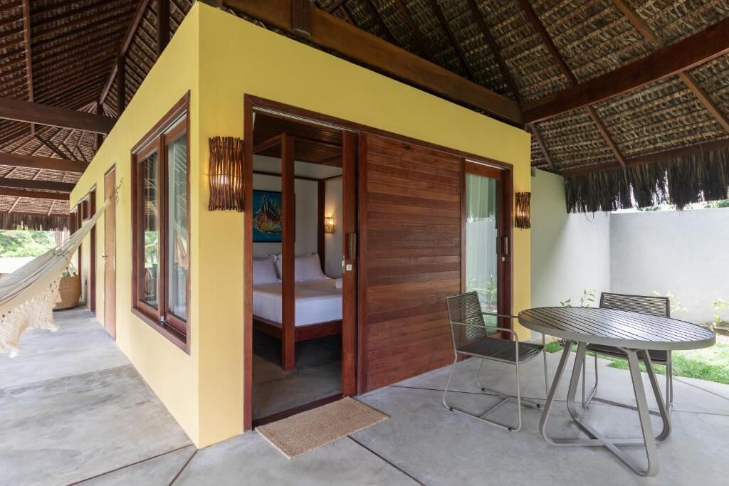 A room with a bed, a table, and a chair.
