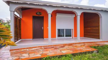 Stunning building with a central entrance and a tiled patio area.