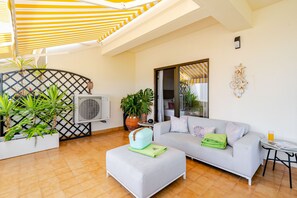 A modern living room with a grey sofa, a small table, and a potted plant. - Inema Homes: Stunning Ocean Views, Inema Homes (Lagos)