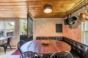 Enjoy meals in this cozy dining area with a round table and comfortable booth seating.