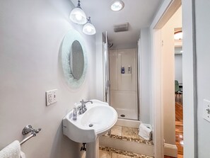 Shower, hair dryer, towels, toilet paper