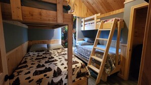 A bunk bed room with a ladder, wooden walls, and a window with a view of greenery. - The Pull Down House! Brand New Utopia! (Jackman)