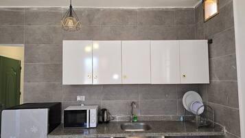 Fridge, microwave, stovetop, cookware/dishes/utensils