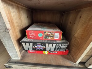 A wooden box containing three puzzle boxes.