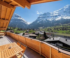 Enjoy breathtaking views of the surrounding mountains and village from this balcony.