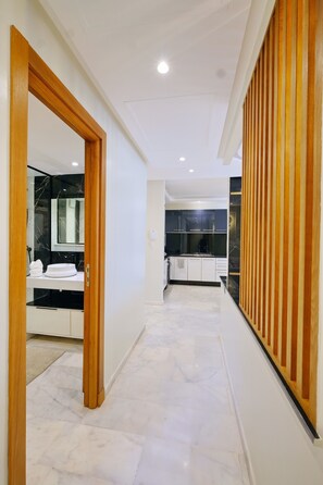 A modern interior with a hallway leading to a kitchen area. - Calm and luxury (Marrakech)