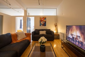 Relax in this stylish living room with a sofa, coffee table, and flat-screen TV.