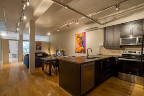 Enjoy cooking in this well-equipped kitchen with a central island, sink, and stainless steel stove.
