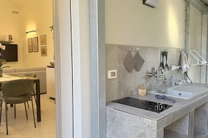 A modern kitchen with a built-in stove, a sink, and a countertop.