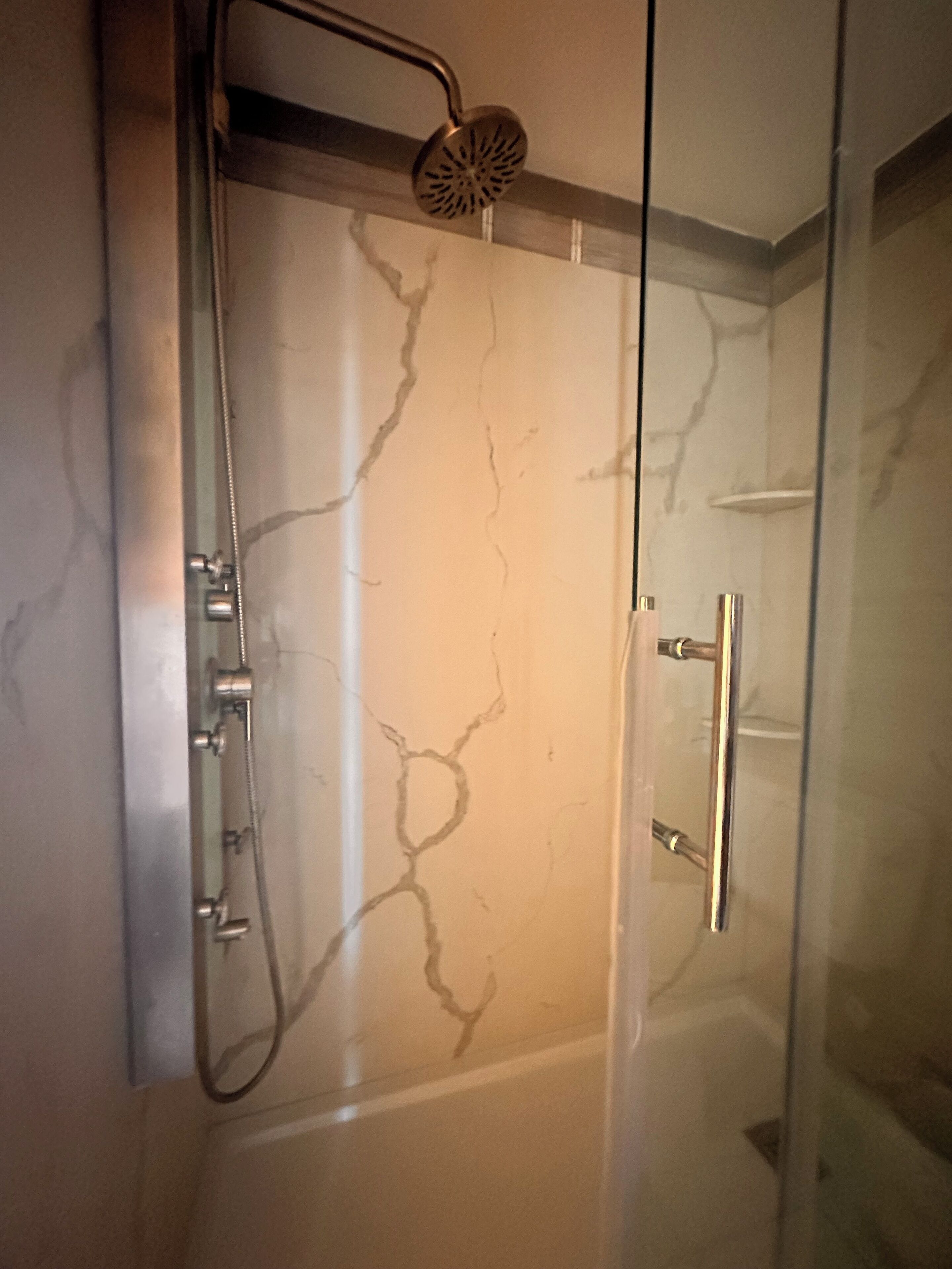 Shower, hair dryer, towels, toilet paper