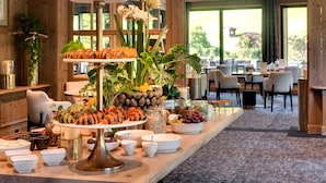 A buffet setup with various food items and a tiered serving stand. - Domaine de Montagne  Chalet Frère Joseph (Ventron)
