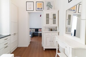 A room with white cabinetry, a dining table, and a sofa.