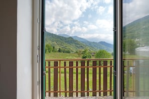 A balcony with a view of a mountainous landscape.