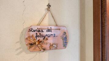 A wall-mounted decorative item with text and a bow.