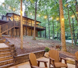 A cabin with a wooden deck and outdoor seating area. - Smoky Mountain Cabin Near Hiking~Hot Tub, Fire Pit, Pet-Friendly (Sevierville)