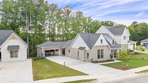 A residential area with modern houses featuring brick exteriors, large windows, and attached garages. - Plainsman Retreat-4min to AU, Gameroom,Pickleball+ (Auburn)