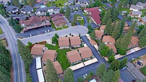 Vue aérienne d’un quartier résidentiel avec des maisons, des rues et un parking.