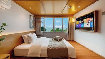 Habitación junior doble, vistas parciales al mar | Ropa de cama de alta calidad y edredones de plumas