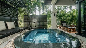 A hot tub area with a tiled floor, surrounded by a seating area with cushions and a wooden bench. - Lilac 1 Bedroom Private Pool Villa Rawai (Rawai)