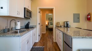 A kitchen with granite countertops, stainless steel appliances, and white cabinetry. - New 1 Bed Near Yosemite, Fire Pit, Washer, Dryer (Mariposa)