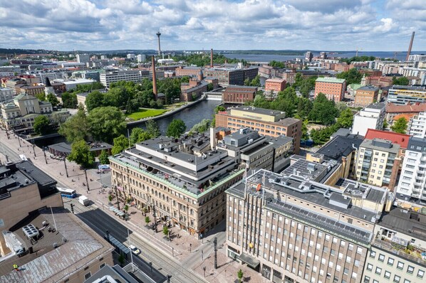 A cityscape with a river, historic buildings, and modern architecture.
