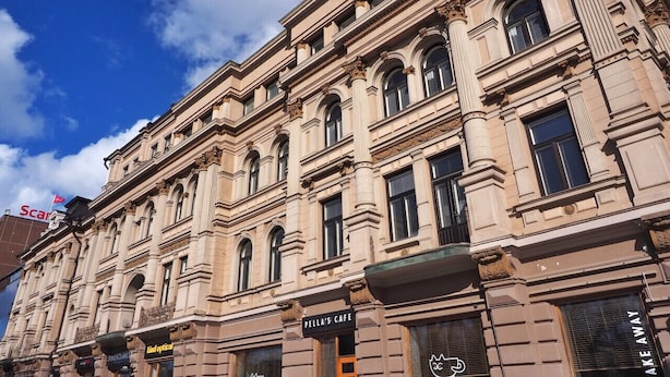 A historic building with ornate architectural details, including arched windows and decorative moldings. - Renovated Loft in a Historical Downtown Building (Tampere)