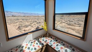 A room with two large windows offering a view of a desert landscape. - Summit Sanctuary: 360° Views (Lone Pine)