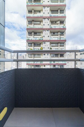 A balcony with a view of a multi-story building.