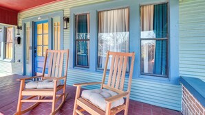 A porch with two rocking chairs and a mailbox.