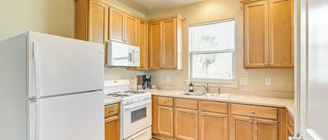 Enjoy cooking in this well-equipped kitchen with an oven, microwave, and sink.