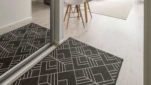 A modern, well-lit room with a bed, bedside table, and a window with curtains. - Cozy 1BR Downtown Home next to all Restaurants (Tampere)