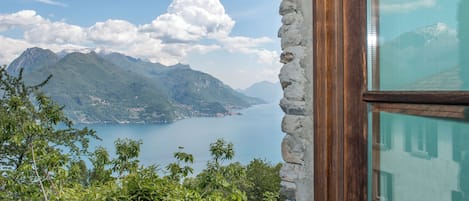 A mountain landscape with a lake and a stone wall.