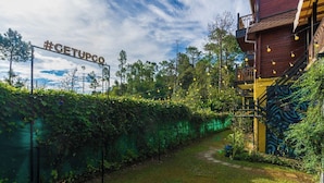 A rustic building with a wooden staircase and a sign reading "#GETUPGO". - The Hosteller Kasar Devi (Almora)